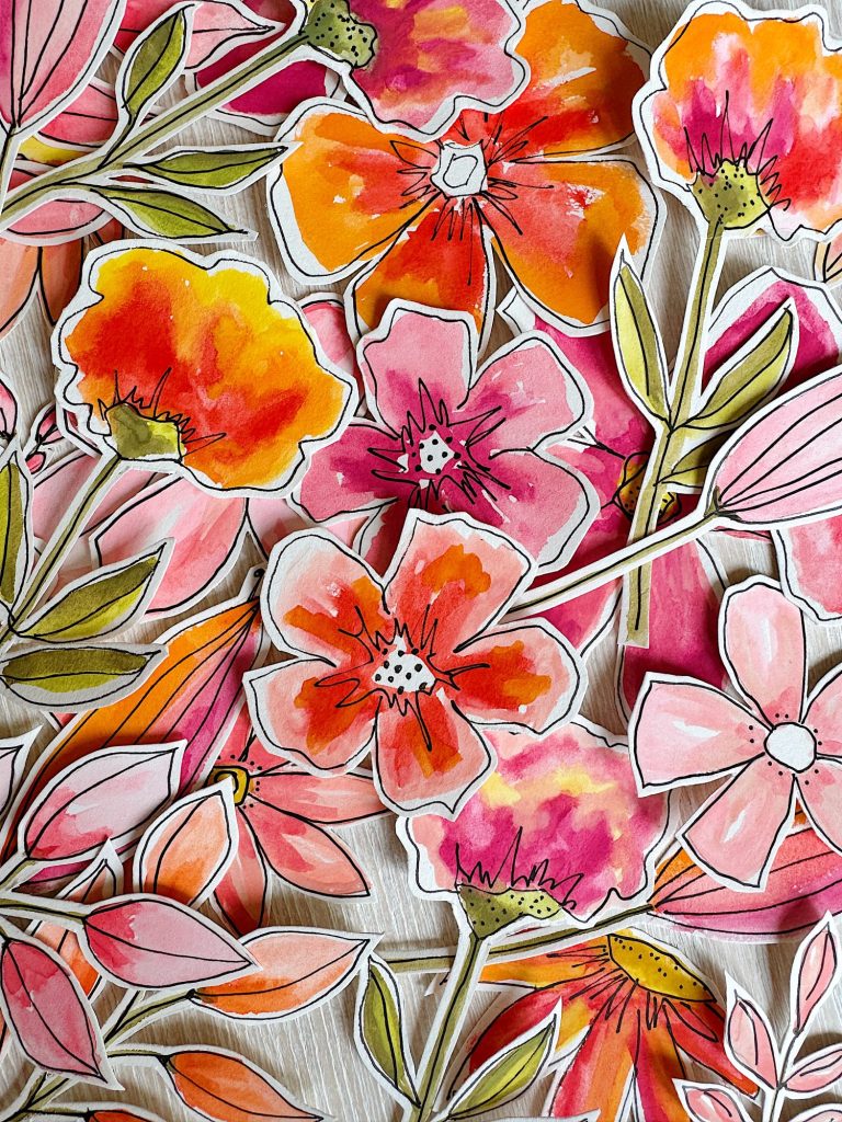A collection of colorful, hand-painted floral cutouts with shades of pink, orange, and red, featuring black outlines and green leaves, arranged on a light surface.