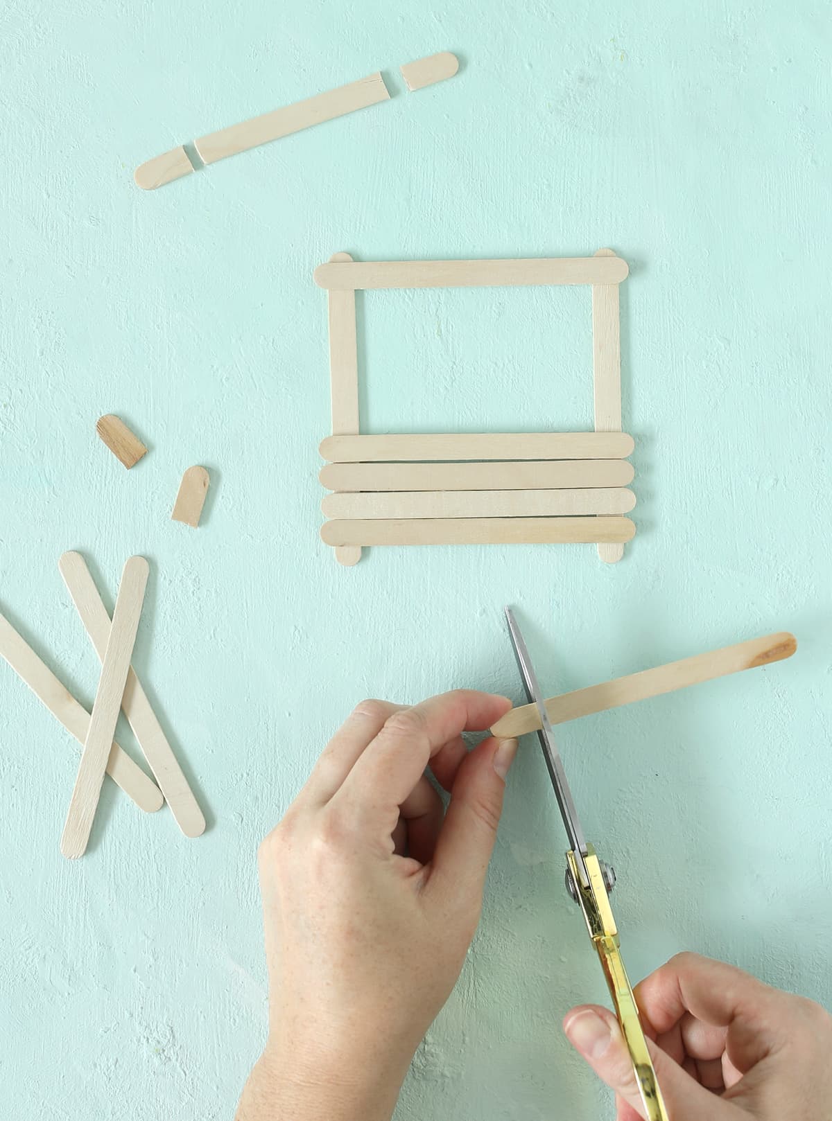 cut popsicle sticks with scissors